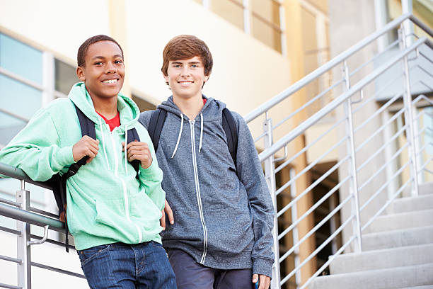 istock Two Male High School Students Standing Outside Building 497015337
