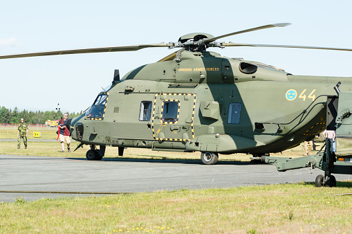 Kallinge, Sweden - June 01, 2014: Swedish Air Force air show 2014 at F 17 Wing. Green  NHIndustries; NH90, hkp 14, on ground. People looking at it.