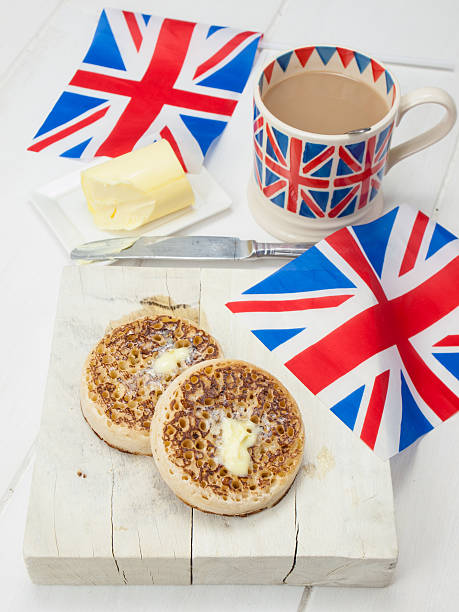 istock Buttered English crumpets with cup of tea and flags 497018539