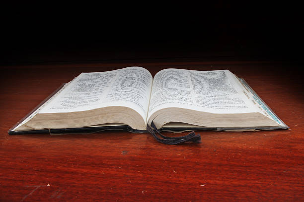 istock Open Bible in front of a wood background. 497018987