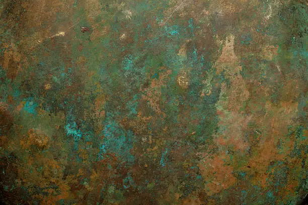 Detail view of on old scratched copper vessel surface texture.