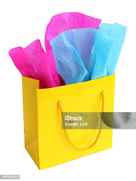 Yellow Gift Bag Stuffed With Pink And Turquoise Tissue Paper Stock