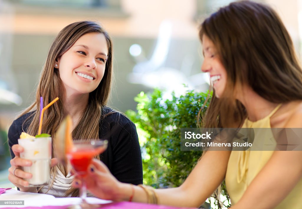 Two girls having an aperitif outdoor Adult Stock Photo