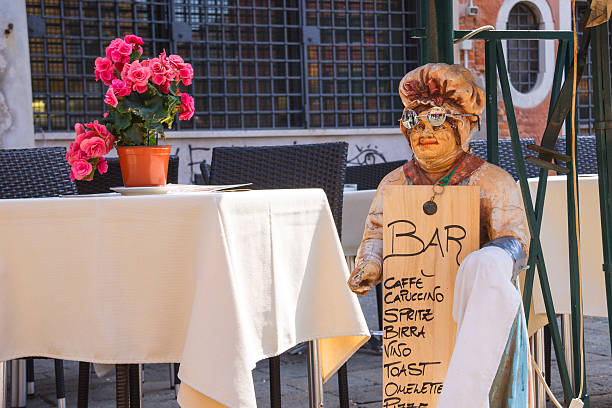 Mannequin welcoming cook in an outdoor cafe,Venice, Italy Venice, Italy - May 6, 2014: Mannequin welcoming cook in an outdoor cafe,Venice, Italy daequan cook stock pictures, royalty-free photos & images