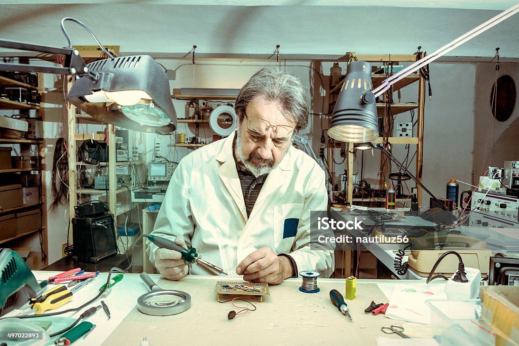 electronic engineer in the laboratory with a soldering iron Adult Stock Photo