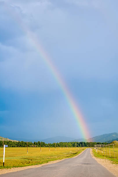 istock Rainbow above road in Mountain Altai. Russia 497023624