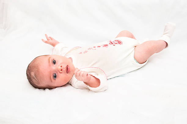 istock Baby girl lying on white 497024088