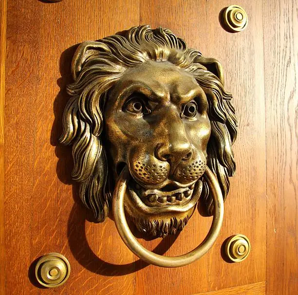 Side view of a doorhandle in the form of the head of a golden lion in the Royal Łazienki Museum in Warsaw, Poland.