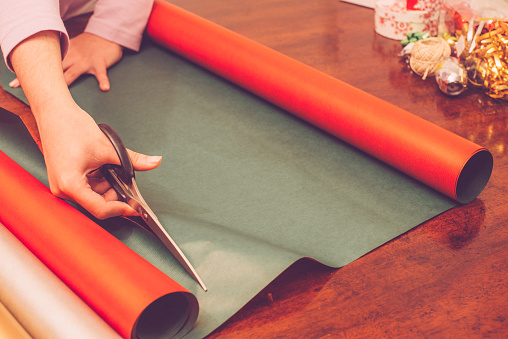 Woman cutting wrapping paper