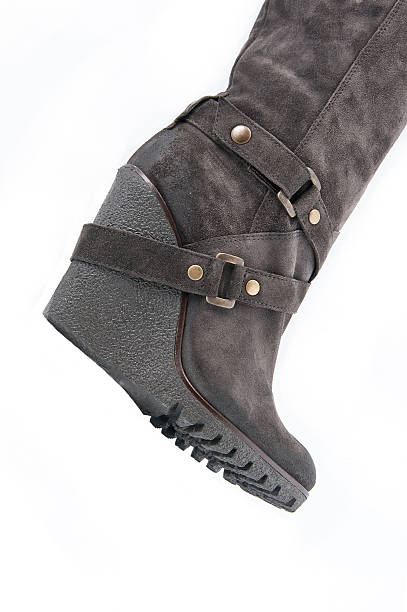 istock Women's brown suede boots with high wedges (part). 497025706