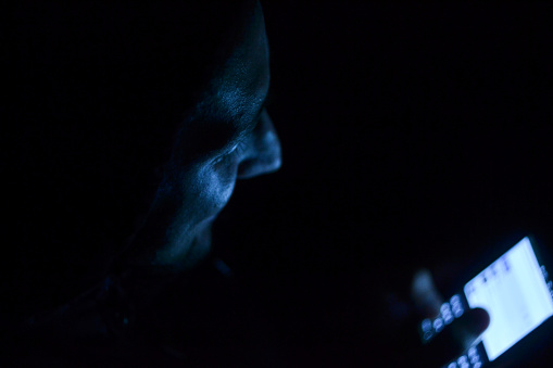 Guy texting in the dark