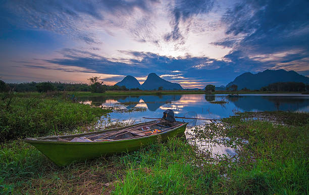 istock fisherman's boat near lake shore 497027250