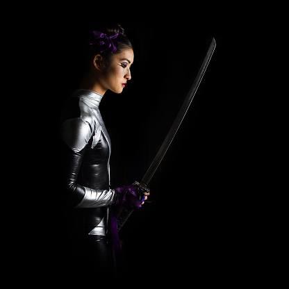 Chinese superhero warrior woman with katana sword against a black background.