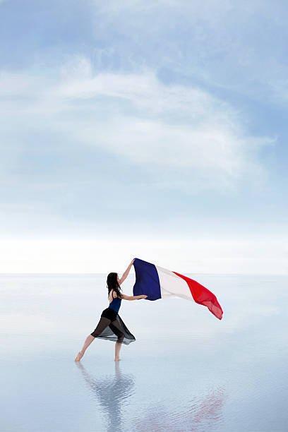 Female dancer carrying French flag waving in the wind outdoors Salt Lake in Turkey ballerina shadow stock pictures, royalty-free photos & images