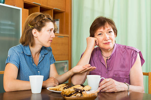 istock Aged pensioner woman and her daughter tea-drinking 497029526