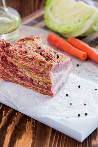 Smoked Meat with Vegetables on Brown Wooden Table stock photo