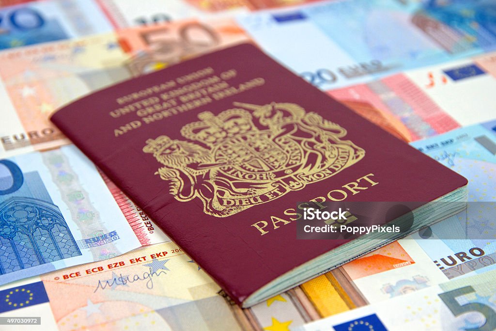 British Passport and Euros Currency Travel Concept UK Passport with Euros Currency Notes as a background 2015 Stock Photo