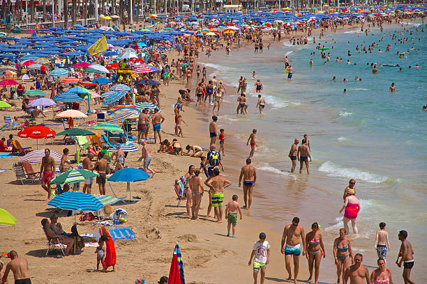 Benidorm, Spain - August 20, 2015: Crowded Levante Beach, Mediterranean Sea in Benidorm on the Costa Blanca, province of Alicante in Spain.