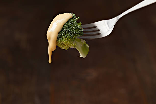 Bite Of Broccoli Wit Cheese Sauce stock photo