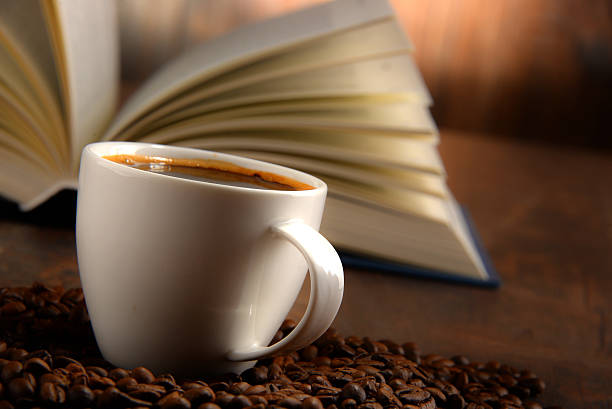 istock Composition with white cup of coffee and open book 497033168