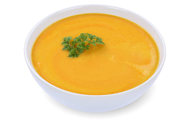istock Carrot soup with carrots in bowl isolated 497033184