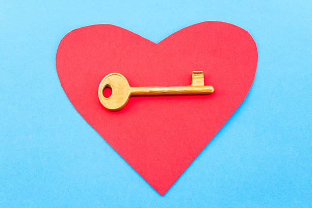 istock Red heart and a golden key on a blue background 497033440
