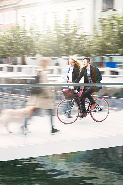 istock businessman with bicycle and his colleague commuting 497033616
