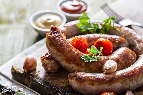 istock Grilled sausages served on wood board 497035720