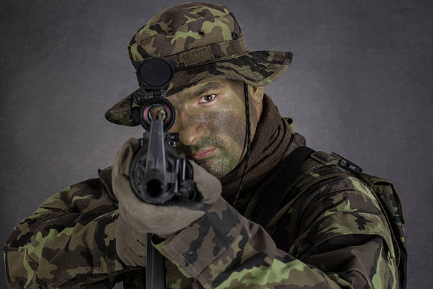 istock Soldier in camouflage and modern weapon M4. 497035825