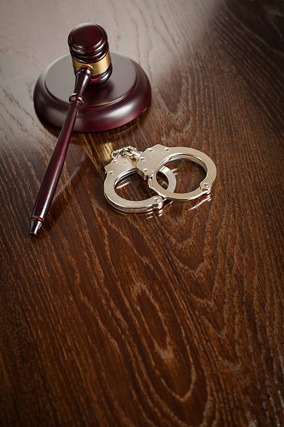 istock Gavel and Pair of Handcuffs on Table 497035895