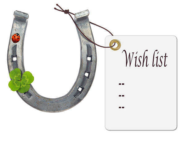 Wish list on a horseshoe with four-leaf clover and ladybug