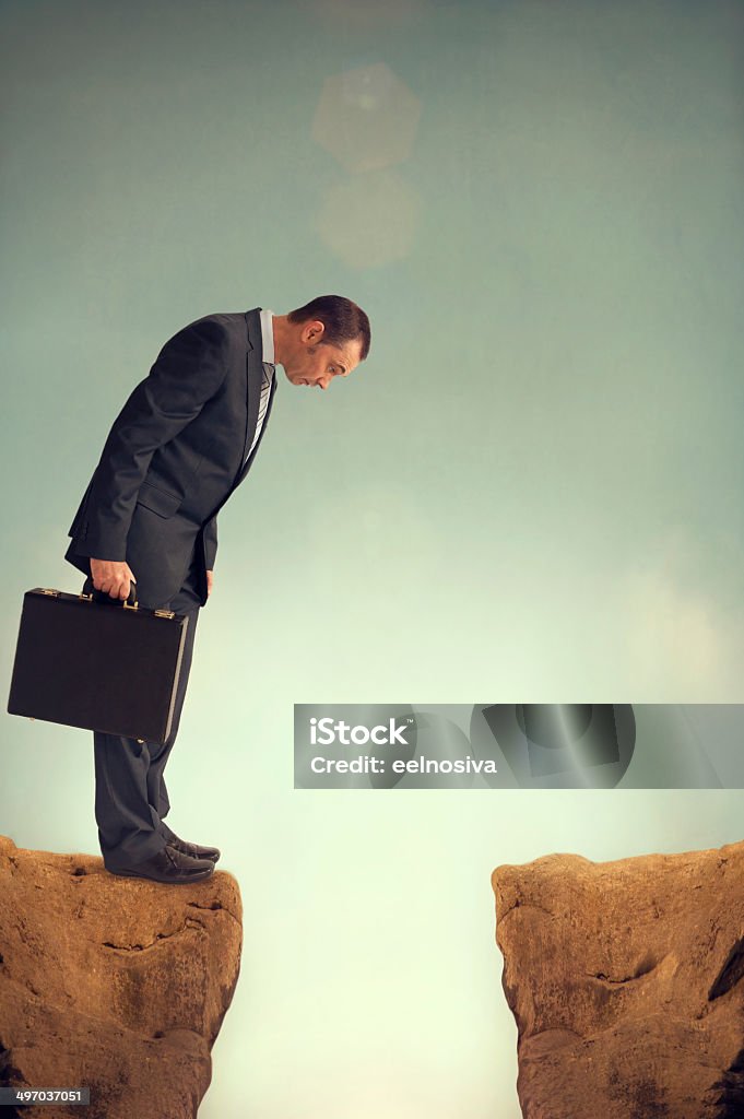 businessman on the edge businessman on the edge of a ravine At The Edge Of Stock Photo