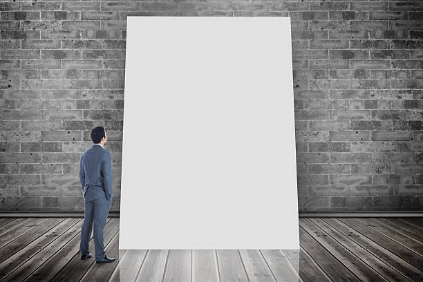 istock Composite image of businessman looking at white card 497037867