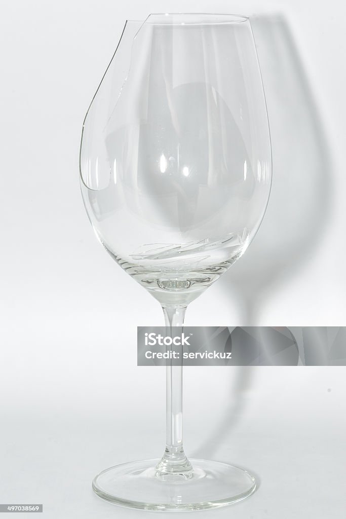 Broken clear wineglass with sharp glass fragments inside Broken clear wineglass with sharp glass fragments inside on white background Alcohol - Drink Stock Photo