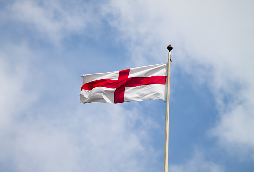 The English flag (the Cross of St George) flying at full mast.