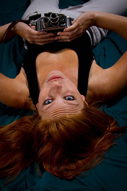 istock Girl on floor holds camera 497039659