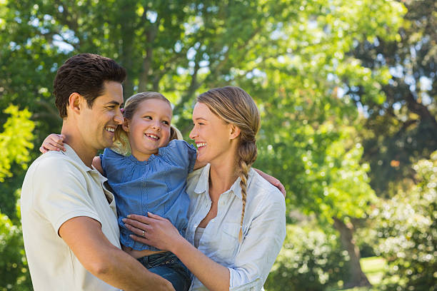 istock Parents with their cheerful daughter at park 497040641