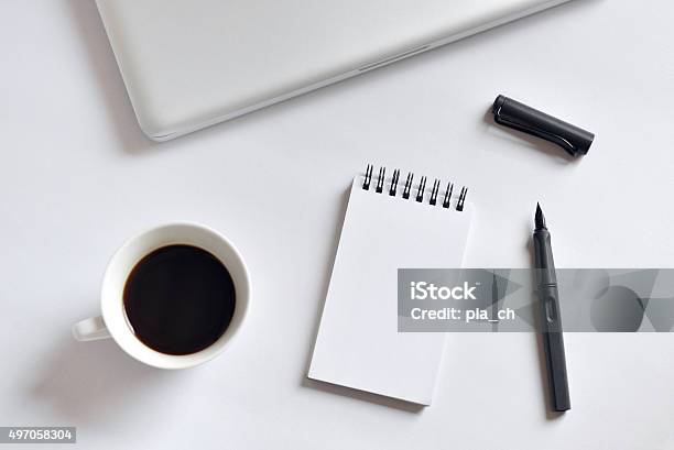 Coffee Cup Spiral Notebook Laptop And Pen On White Background Stock Photo - Download Image Now