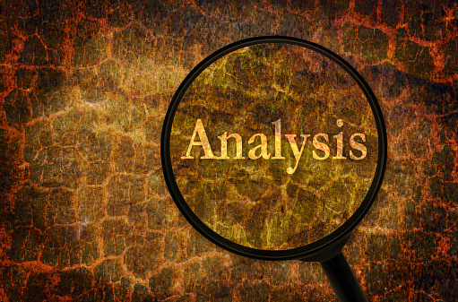 Word Analysis under a magnifier written on abstract background. Strange textured background as a subject of research and analyzing.