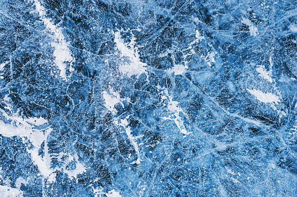 istock Blue ice with cracks and bubbles on the frozen lake. 497062146