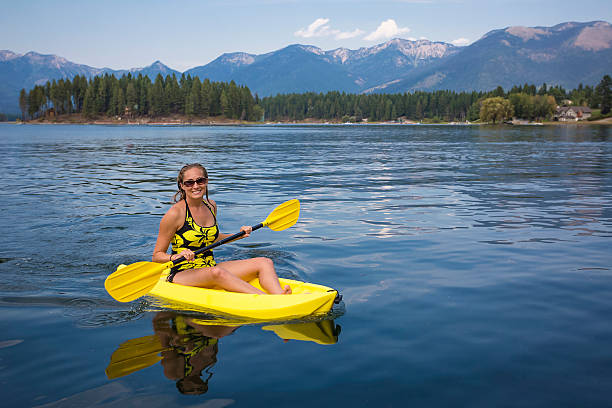 istock Active, Fit woman kayaking on a beautiful Mountain lake 497062394