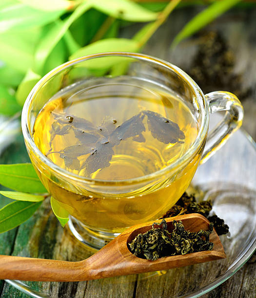 istock Cups of green tea on table on wooden background 497062978