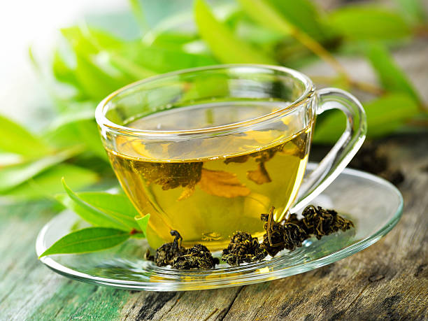 istock Cups of green tea on table on wooden background 497063456