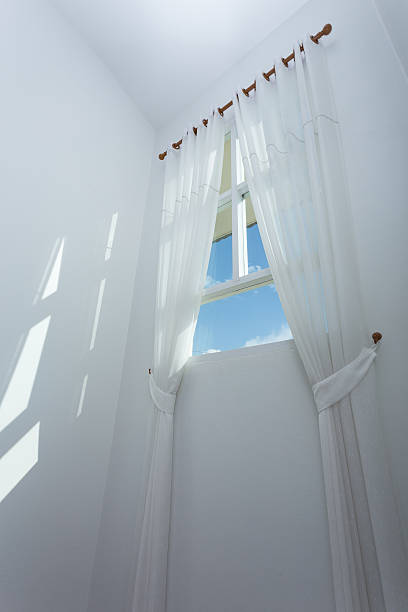 istock white curtain on the window with blue sky 497067434