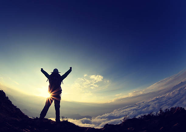 istock silhouette of backpacker hiking on sunset mountain peak 497067880