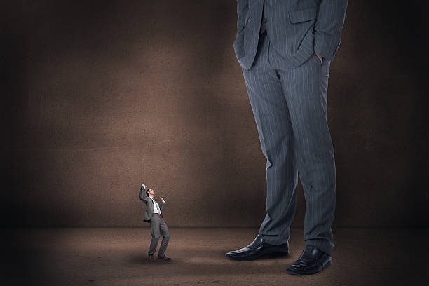 istock Composite image of businessman posing with hands up and giant 497074625