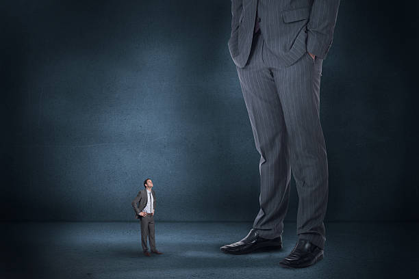 istock Composite image of serious businessman with hands on hips and 497074633