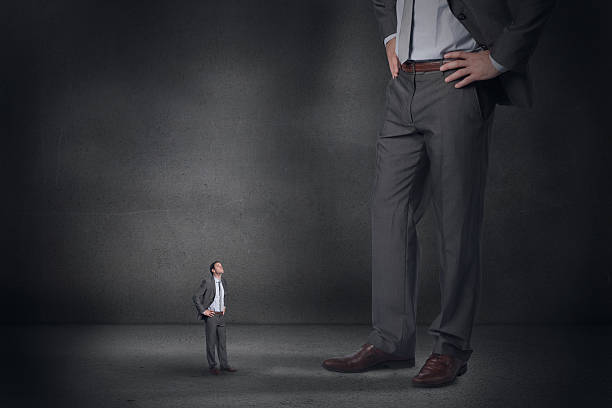 istock Composite image of serious businessman with hands on hips and 497074653