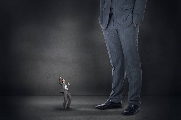 istock Composite image of businessman posing with hands up and giant 497078427
