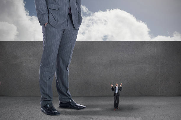 istock Composite image of stressed businessman gesturing and giant busi 497078461